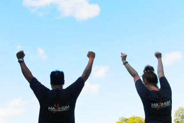 MPC students With their hands in the air, wearing Maximum potential calisthenics t-shirts