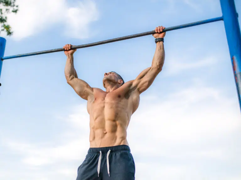 Man doing a pull up outdoors - calisthenics