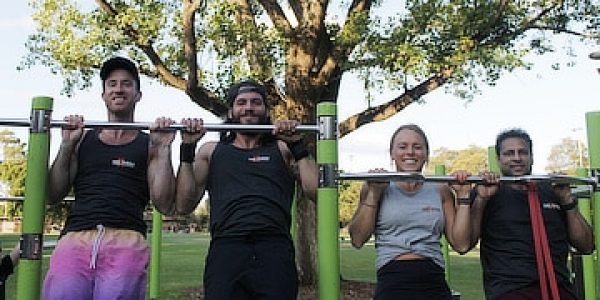 3 students and the coach doing a pull up